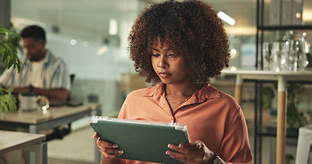 istock Focused Professional Working in a Modern Office Environment with Tablet 2231732831