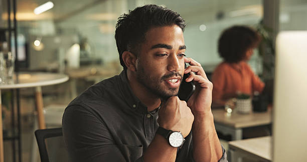 istock Professional Office Worker Communicating on Phone During Work Hours at a Desk 2231732888