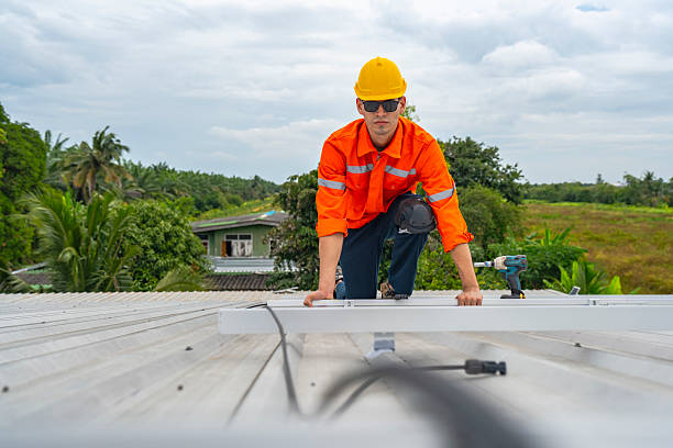 istock Technician in safety uniform and helmet kneeling on a rooftop, using a drill for precise installation work. A scene highlighting safety, professionalism, and technical expertise in construction. 2231734625