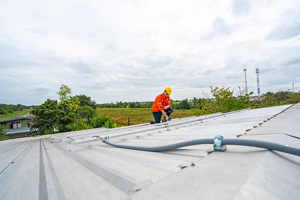 istock Technician in safety uniform and helmet kneeling on a rooftop, using a drill for precise installation work. A scene highlighting safety, professionalism, and technical expertise in construction. 2231734753