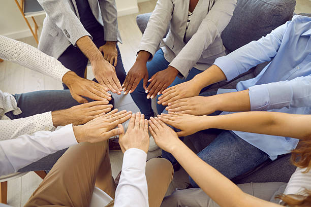 istock Different multiracial men and women form circle with their hands showing their unity and equality. 2231736696