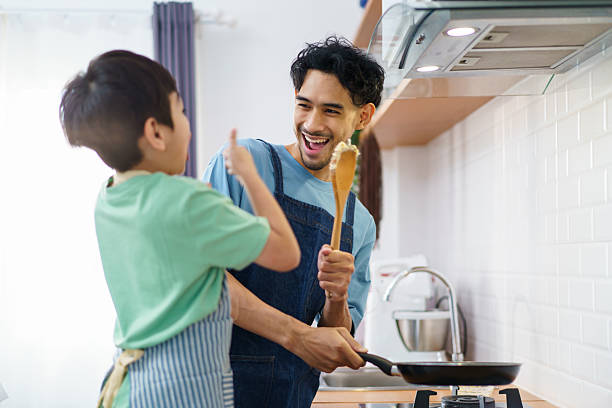 istock Asian man with young son are enjoy cooking together in kitchen at home in weekend. 2231739708