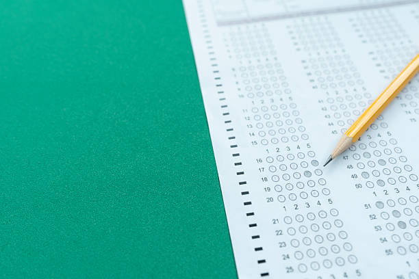 istock close up pencil  on answer sheets with green background, education concept 2231744354