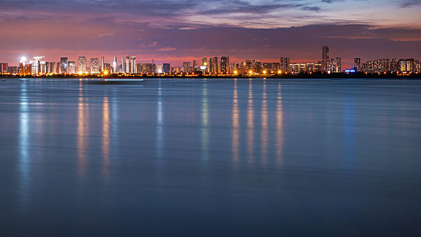 istock Dramatic sky and clouds with modern urban waterfront skyline at night 2231746978