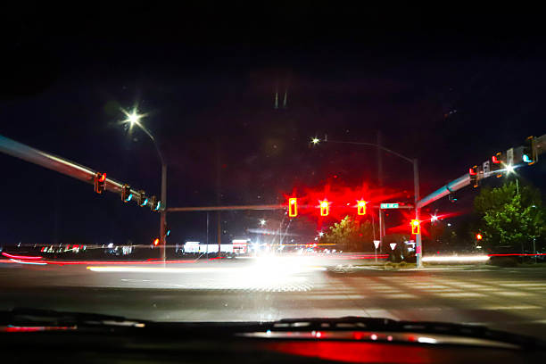 Abstract light trails captured in motion blur of traffic and streetlights at night. Vibrant colors of red, green, yellow, and white create a dynamic, painterly effect that conveys energy, nightlife, and urban movement. Perfect for concepts of speed, city nightlife, transportation, and artistic backgrounds.