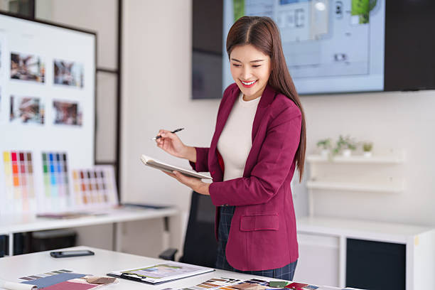 istock Asian adult architect designing interior spaces at a modern office creative professional planning home construction blueprints 2231757660