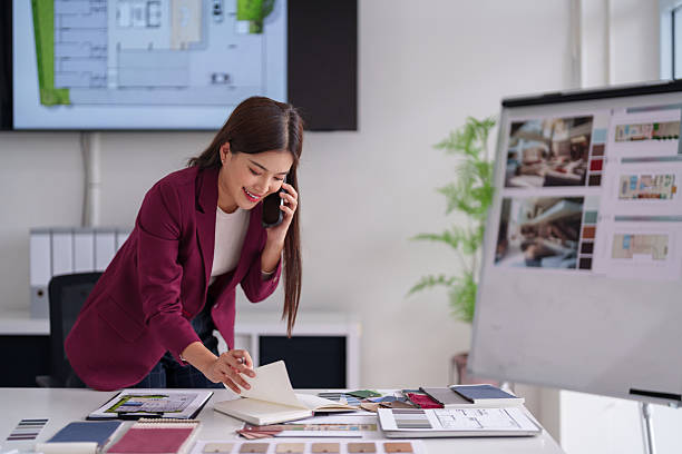 istock Asian Woman Architect Consulting Client Discussing Home Design Plans Materials Office 2231757671