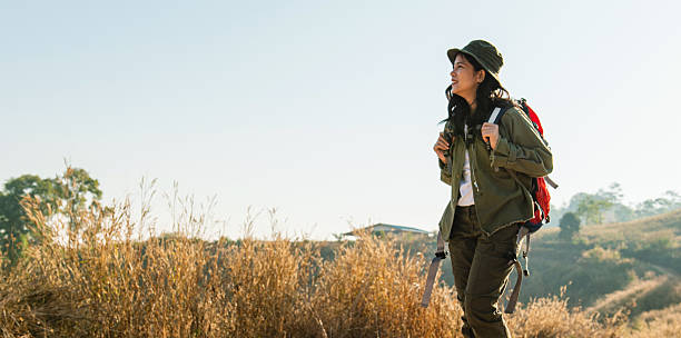 istock woman is walking in the wilderness with  backpack on her back 2231762175