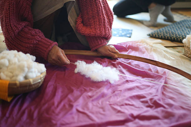 istock A woman shooting cotton with a cotton bow 2231764050