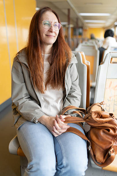 istock Woman relaxing on commuter train during daily commute 2231764739