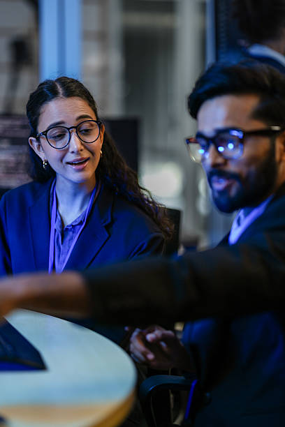 istock A diverse team of AI developers shares a successful moment in the office. A female programmer smiles as they review the positive results of a complex machine learning algorithm. 2231765855
