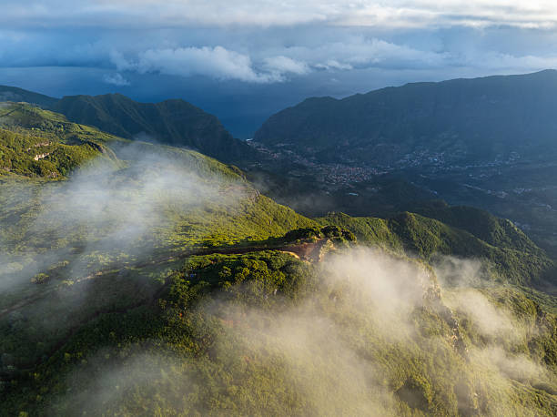 Morning fog wrapping the Bica da Cana viewpoint in Madeira. Aerial view on Sao Vicente village.