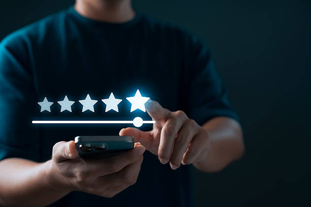 istock five-star rating system and user feedback. Person using smartphone to give top rating through digital interface, representing customer satisfaction and online review experience. 2231770544