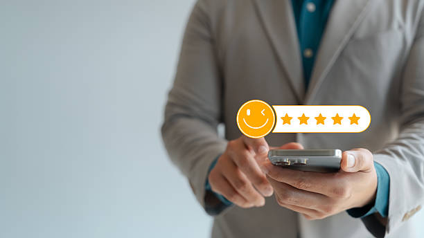 istock Customer feedback and satisfaction rating, businessperson using smartphone to give five-star review, representing digital user experience, service quality, and online reputation management. 2231772012