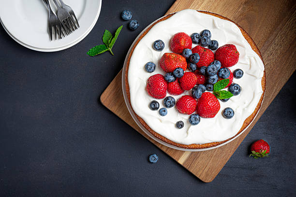 istock Sponge cake with cream cheese and fresh berries 2231773598