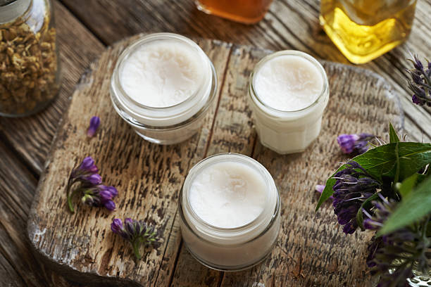 istock Three jars of cooled homemade comfrey root ointment made with rendered pork lard 2231774752