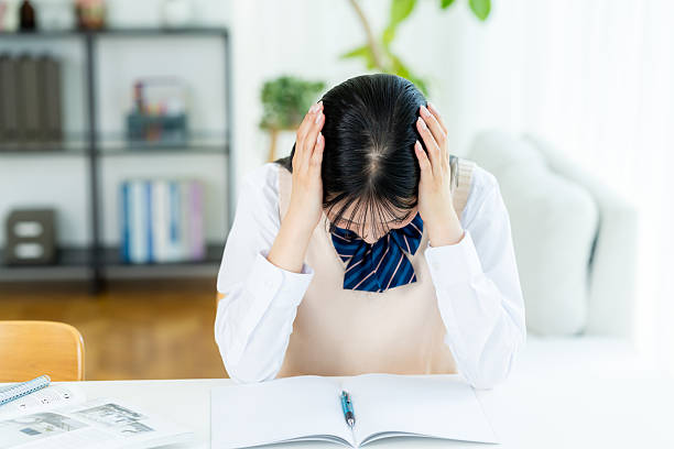 istock High school girl worried while studying at home 2231778608