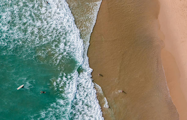 istock Top view beach with waves crashing on sandy shore 2231778840