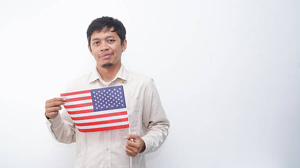 istock Asian Man with USA flag at studio against white background 2231779521