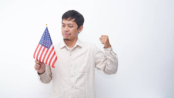 istock Asian Man with USA flag at studio against white background 2231780394
