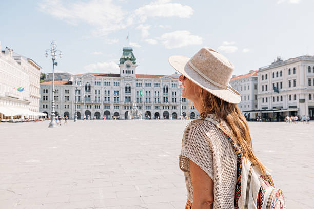 istock Smiling Woman Exploring Historic European Square 2231780577