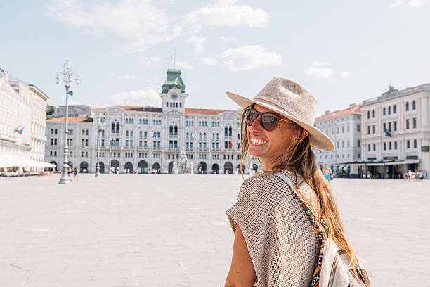 istock Smiling Woman Exploring Historic European Square 2231780578