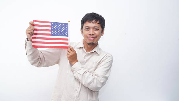 istock Asian Man with USA flag at studio against white background 2231780660