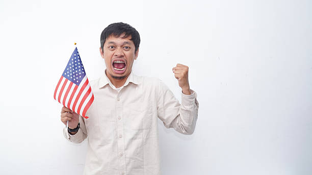 istock Asian Man with USA flag at studio against white background 2231780796