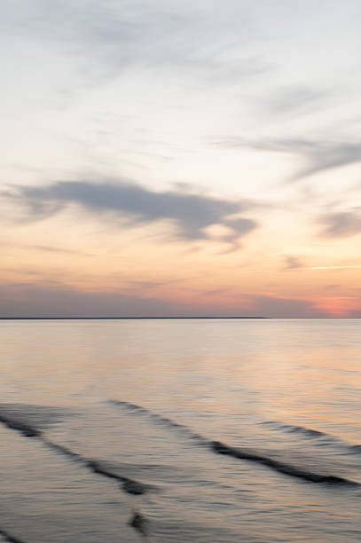 istock A dreamy, impressionistic paint like blurred sea sunset background with gently soft pastel colours. Vertical photo. 2231781997