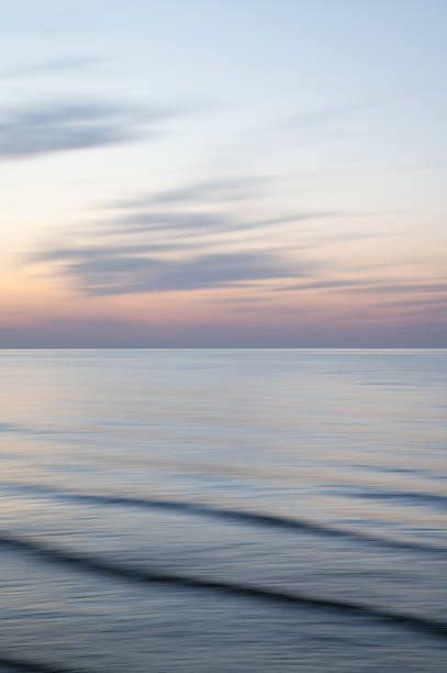 istock A dreamy, impressionistic paint like blurred sea sunset background with gently soft pastel colours. Vertical photo. 2231782062
