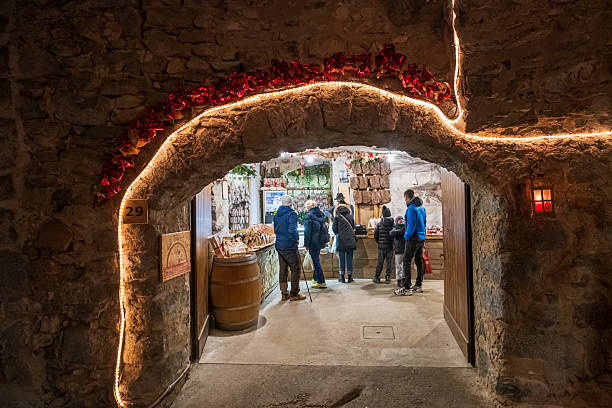 People visit the Christmas market set under the arcades and in the old stone houses of Rango, one of the most characteristic villages in Trentino, northern Italy