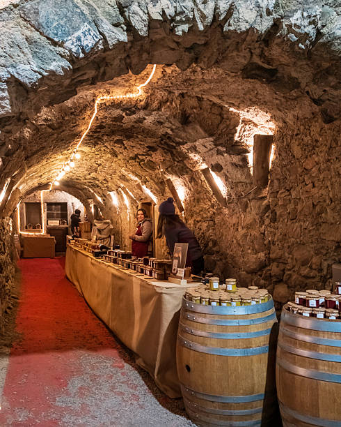 Vendors at the Christmas market set under the arcades and in the old stone houses of Rango, one of the most characteristic villages in Trentino, northern Italy