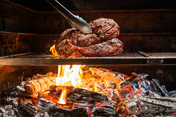 istock Grilled Steak Over Open Fire with Burning Wood and Flames 2231786124
