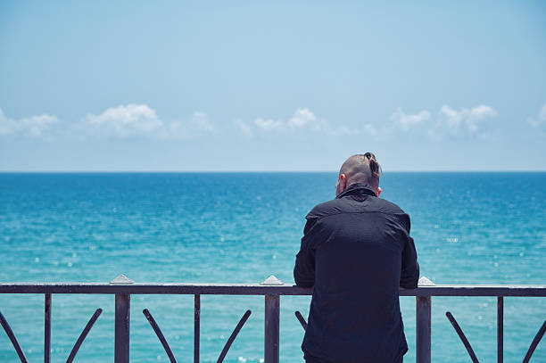 istock Artist reflecting and finding inspiration facing the ocean and the sky 2231786451