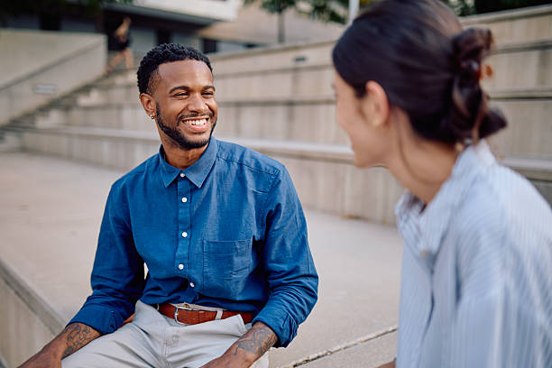 istock Two Young Professionals Having a Conversation Outdoors 2231790016