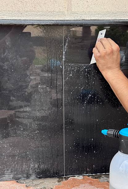 istock Cleaning tiles from greasy deposits hands in progress 2231790375