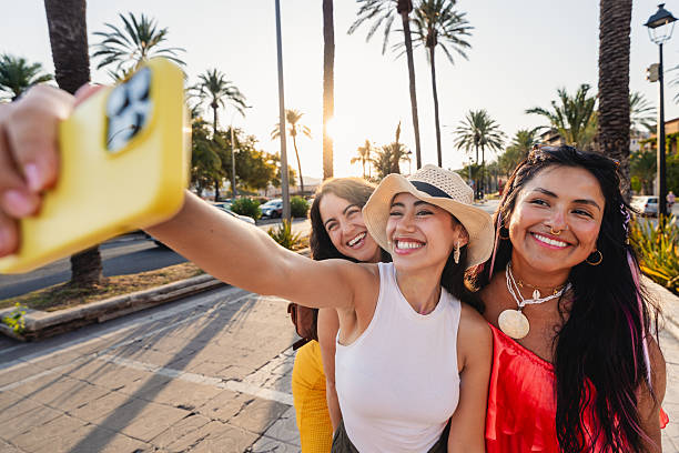 istock Smiling young women taking a selfie together at sunset 2231793803