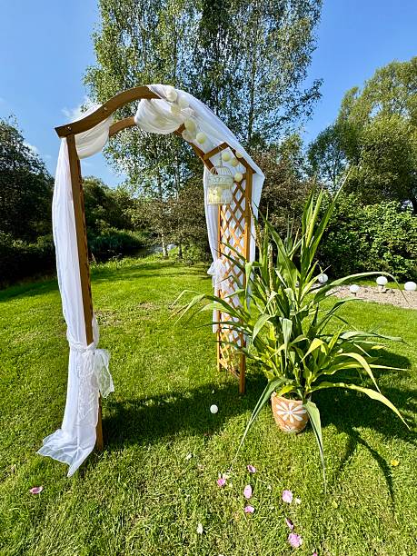 istock Wedding arch with white fabric in green garden 2231795704