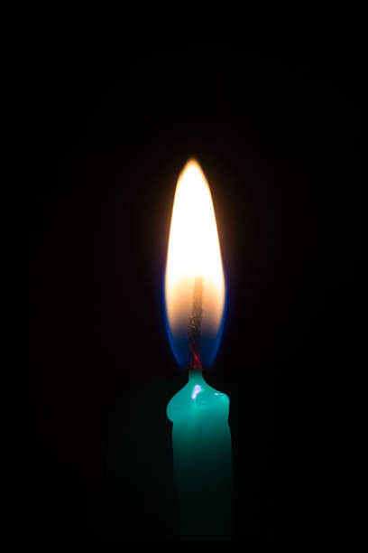 Group of Lit Church Candles, royal blue background.