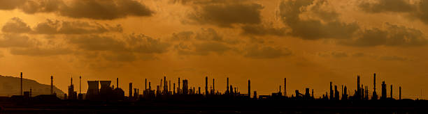 istock Large,Industrial,Chimneys,At,Refineries,Against,The,Cloudy,Sky,At 2231797445