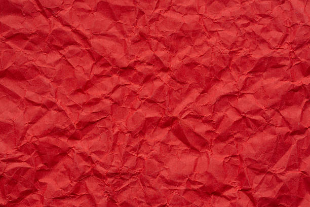 istock Close-up macro of wrinkled red paper texture,Wrinkled red paper texture,Rectangular crumpled sheet of red paper on a white isolated background. 2231798679