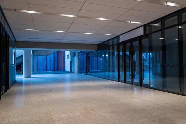 A stylish, modern office corridor with large windows and minimalist design elements, perfect for corporate or commercial use.