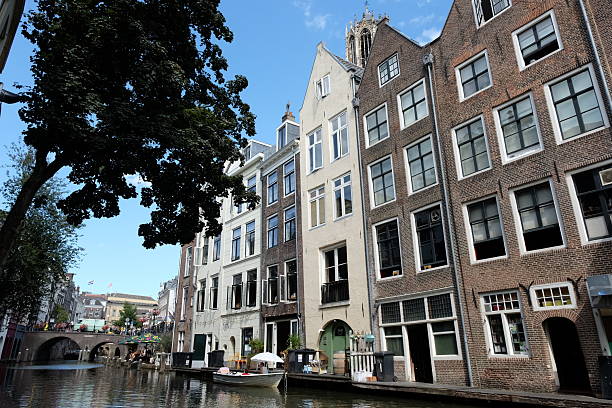 Utrecht, Netherlands - August 19, 2025: Traditional Dutch houses line the Oudegracht or Old Canal in centre of Utrecht, Netherlands.