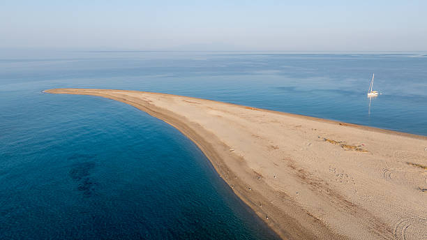 istock Stunning Possidi cape sandbar in Kassandra, Greece, with sailing boat 2231803267