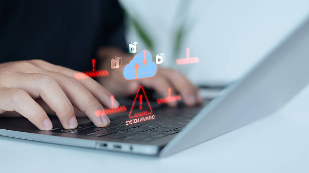istock Hand typing on a laptop with digital cloud warning and alert icons, representing cloud system error, cybersecurity risk, data breach prevention, and online information protection technology concept. 2231805513