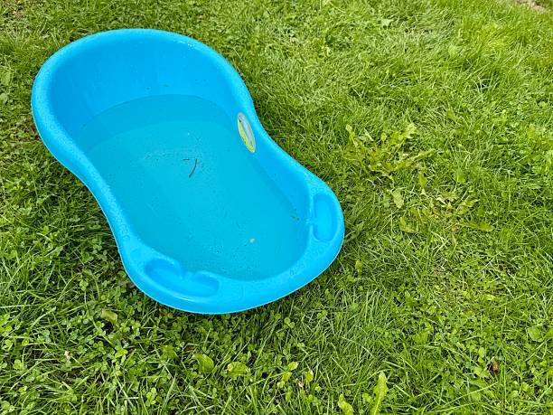 istock Blue plastic bathtub on green grassv 2231806443