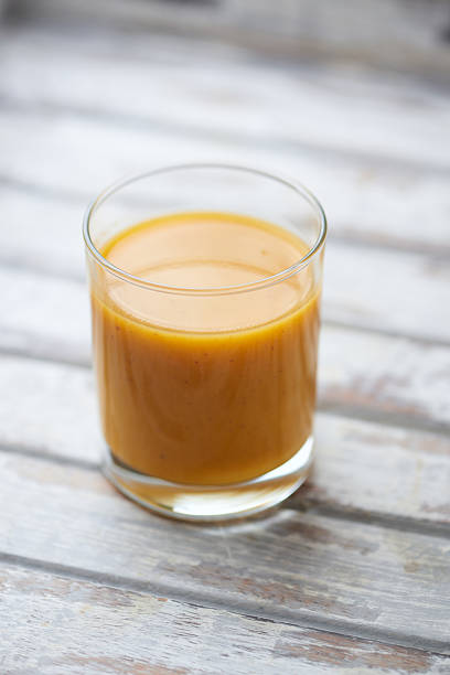 istock Mango smoothie on wooden background. Soft focus. Copy space. 2231807290
