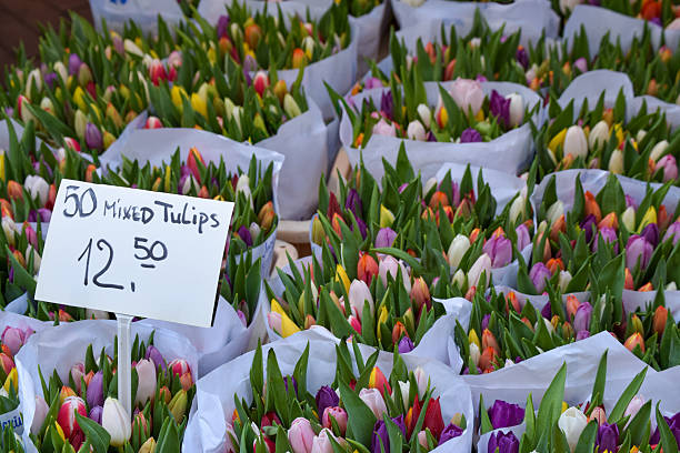 Preparation of bouquets for sale. Street flower vendors for the holiday.