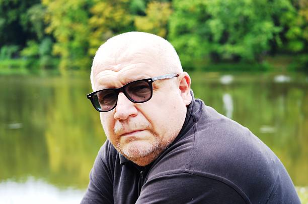 portrait of a male photo model in social protection glasses against the background of a recreation park