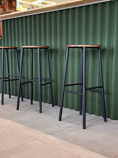 istock Modern green bar counter with high stools in cafe 2231809270